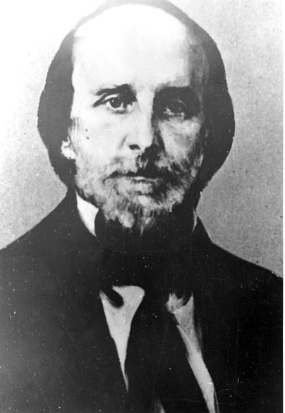 White man with a beard in suit and tie