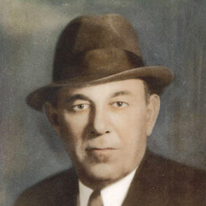 White man in suit and tie with fedora hat