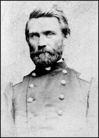 White man with trimmed full beard and mustache in military uniform