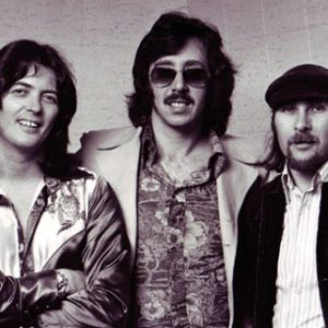 Three white men with long hair in jackets