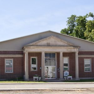 Brick building with four columns and glass doors