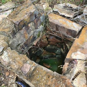Looking down an abandoned brick well
