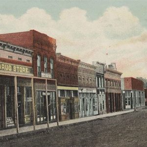 Row of buildings with foremost labeled "Baugh's Drug Store"