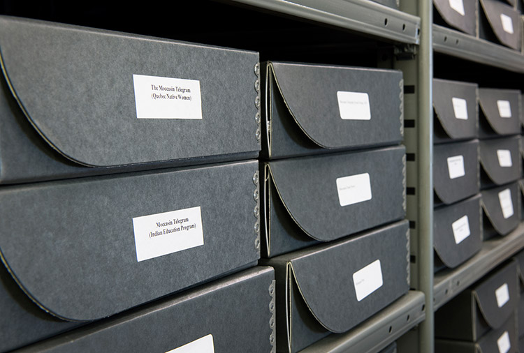 Close-up of archival boxes on metal shelves