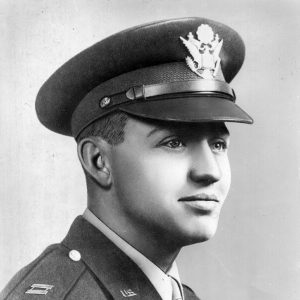 Young white man smiling in military uniform with cap