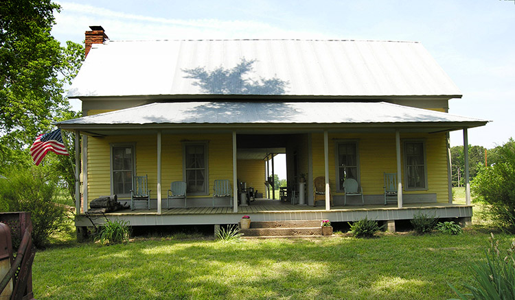 Single-story yellow house with covered porch
