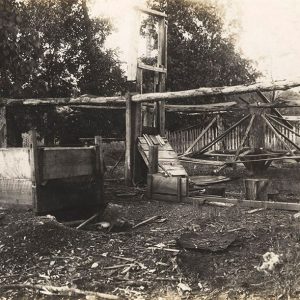 Wooden mill machinery with wooden fence in the background