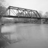 Steel truss bridge with concrete supports over river