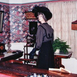 Mannequin in hat and dress in Victorian parlor room