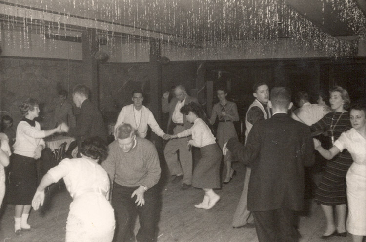 Young white men and women dancing in club