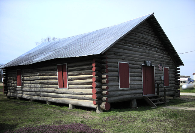 Single-story cabin building with covered windows