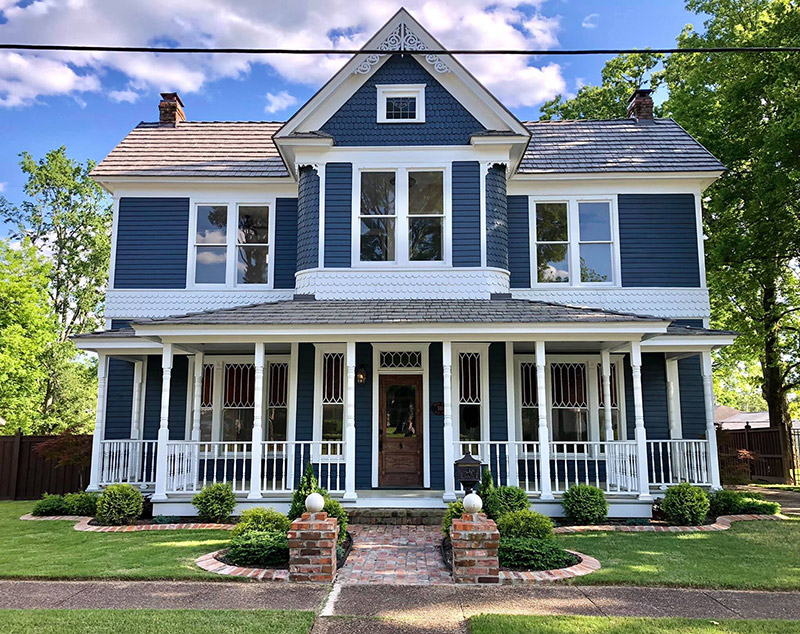 Blue and white two story house with covered porch