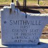 "Smithville first county seat of present Lawrence Co. 1837-1867" engraved on monument cut in the shape of Lawrence County