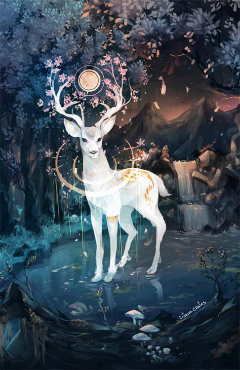 White stag standing in river with waterfall and mountains behind it