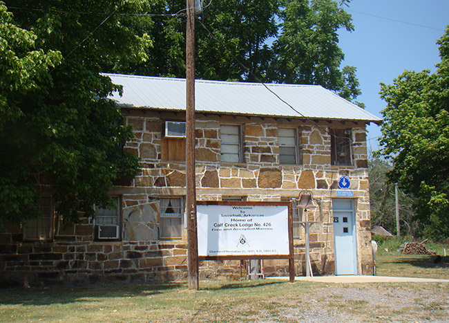 Two-story stone building with sign