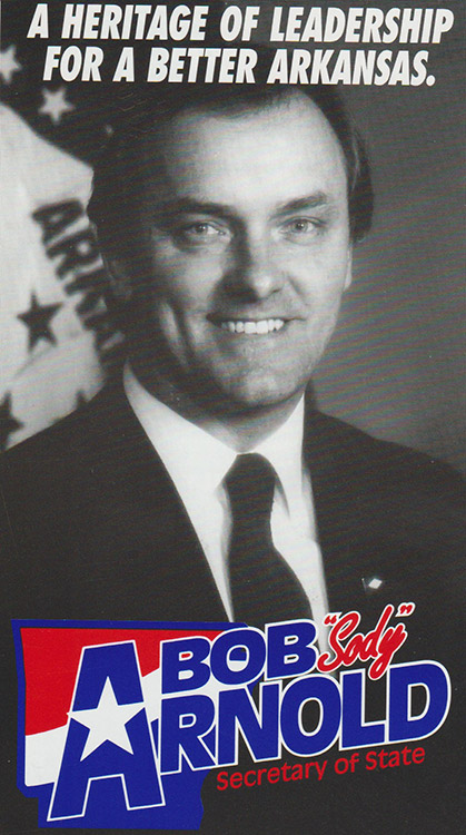 White man smiling in suit and tie with flag behind him with text and logo on campaign brochure