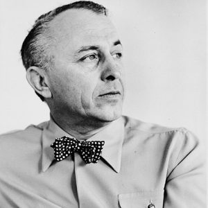 side view of white man in button-down shirt and bow tie