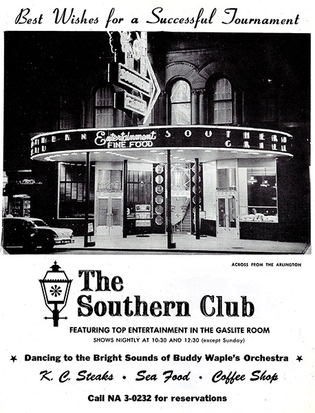 Multistory building with neon lights and "The Southern Club" logo on advertisement