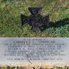 Maltese cross and flat gravestone with engraving in cemetery