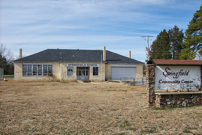 Single-story "Springfield School" building with garage bay