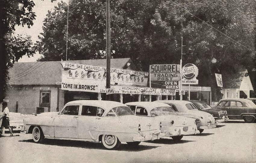 Cars parked in front of "Squirrel Trading Post"