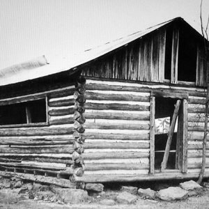 Single-story dilapidated log cabin