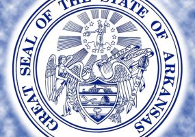 "Great seal of the state of Arkansas" with eagle holding shield and "Regnat Popluas" ribbon in beak with angel mercy on one side and sword of justice on other