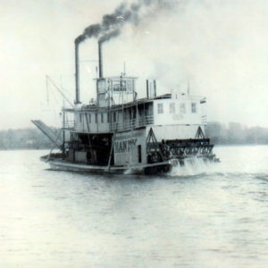Steamboat "Handy" on a river with trees in the background