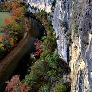 River and rock wall with fall foliage as seen from above