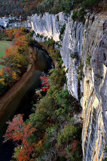 River and rock wall with fall foliage as seen from above