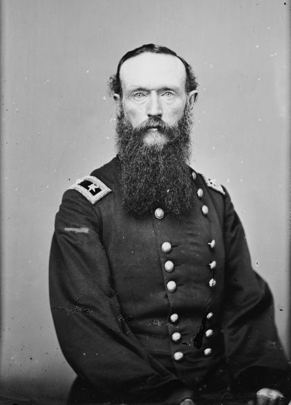 White man with long sideburns and beard in military uniform
