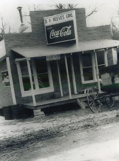 Single-story storefront with Coca-Cola sign and covered porch