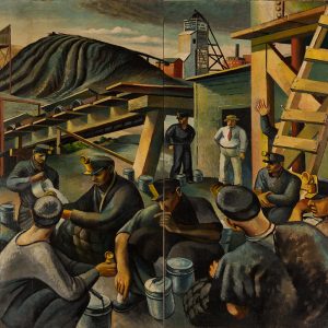 White coal miners gathered outside coal mine with building and tracks in the background