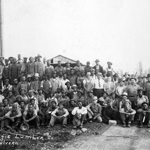 Group of white and African-American workers at lumber mill
