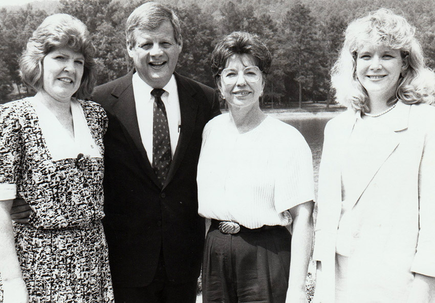 White man in suit and three white women
