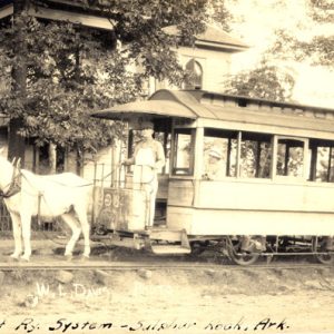 horse-drawn streetcar parked in front of house