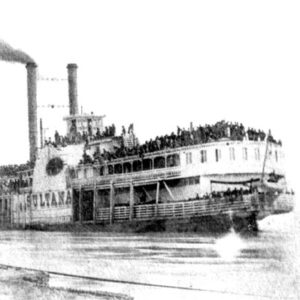 Large crowd on a steamboat with two smoke stacks at boat dock
