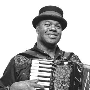 African-American man in long sleeve shirt and hat playing an accordion