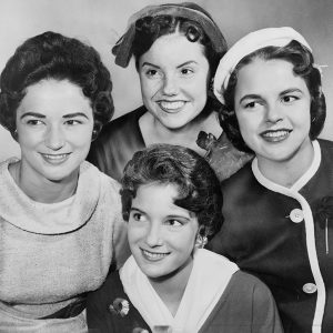 Group of four young white women posing for camera