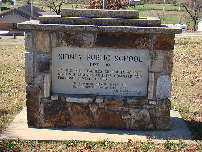 "Sidney Public School" sign on brick pedestal