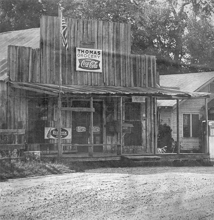 Wooden building "Thomas Grocery" and dirt road
