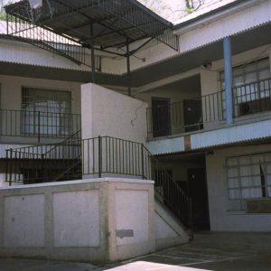 Corner staircase with canopy and street light on motel building