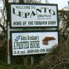 "Welcome to Lepanto Arkansas since 1895 home of the terrapin derby" sign above sign for "John Grisham's A Painted House"