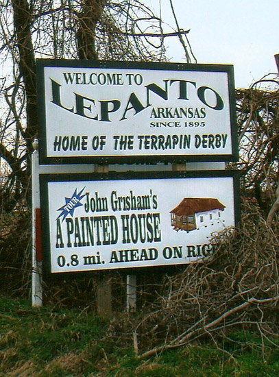 "Welcome to Lepanto Arkansas since 1895 home of the terrapin derby" sign above sign for "John Grisham's A Painted House"