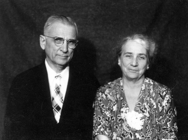 Portrait of smiling white man and woman in formal attire.