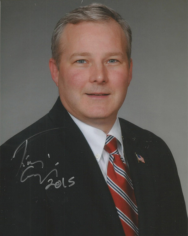 White man smiling in suit and tie signed "Tim Griffin 2015"
