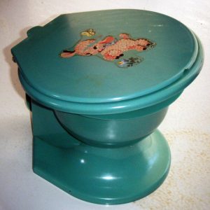 Green toilet with pink lamb and butterfly sticker on its lid