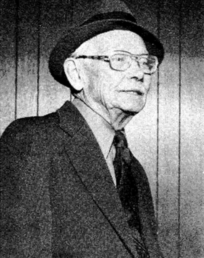 Old white man with glasses in hat and suit