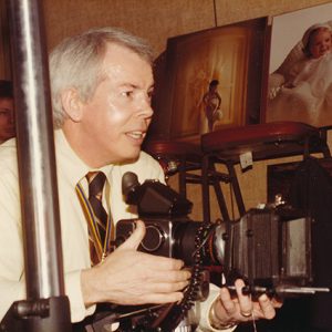 White man in photography studio with camera