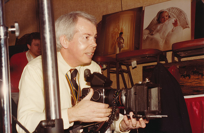 White man in photography studio with camera